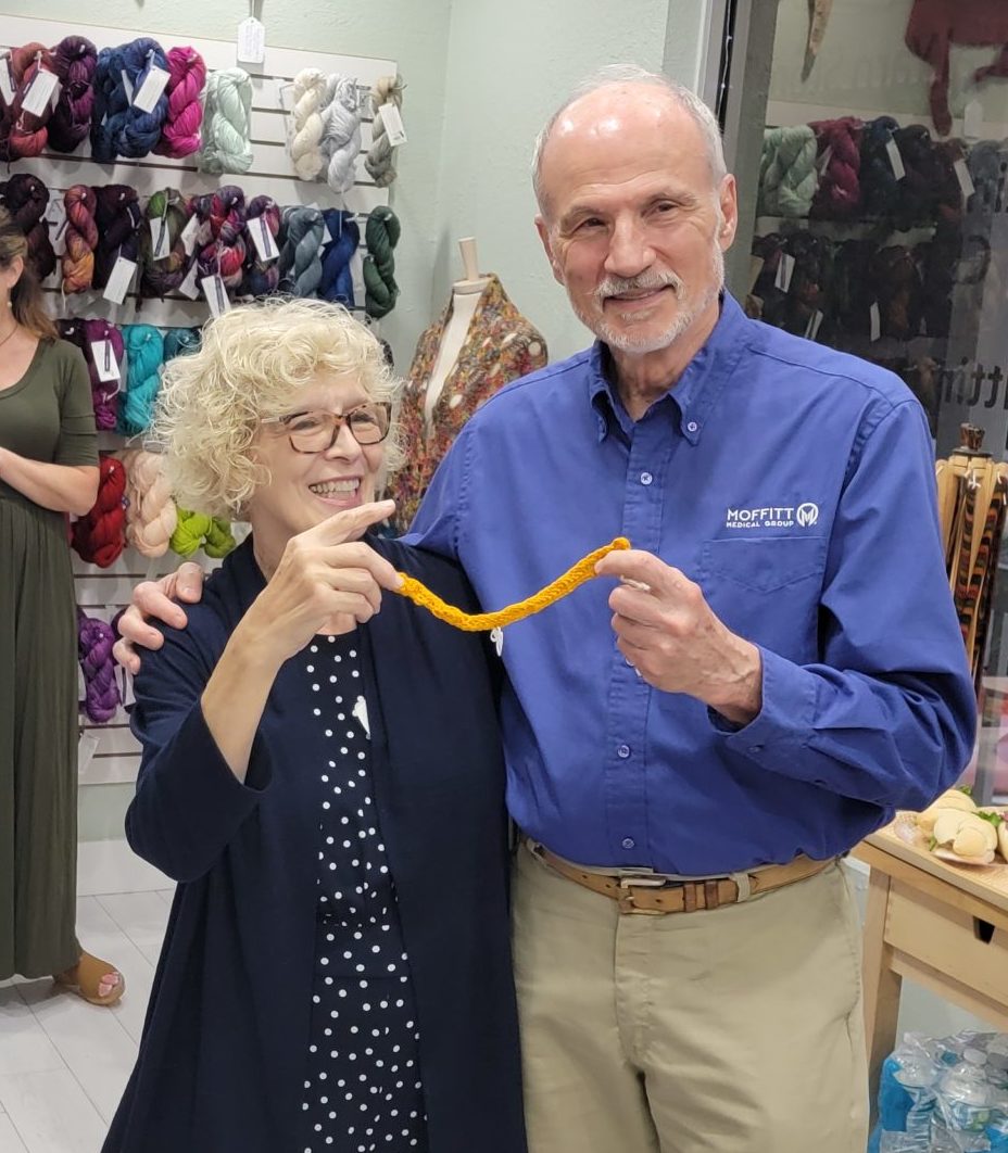 Dr RObinson and Board Member celebrating his knitting
